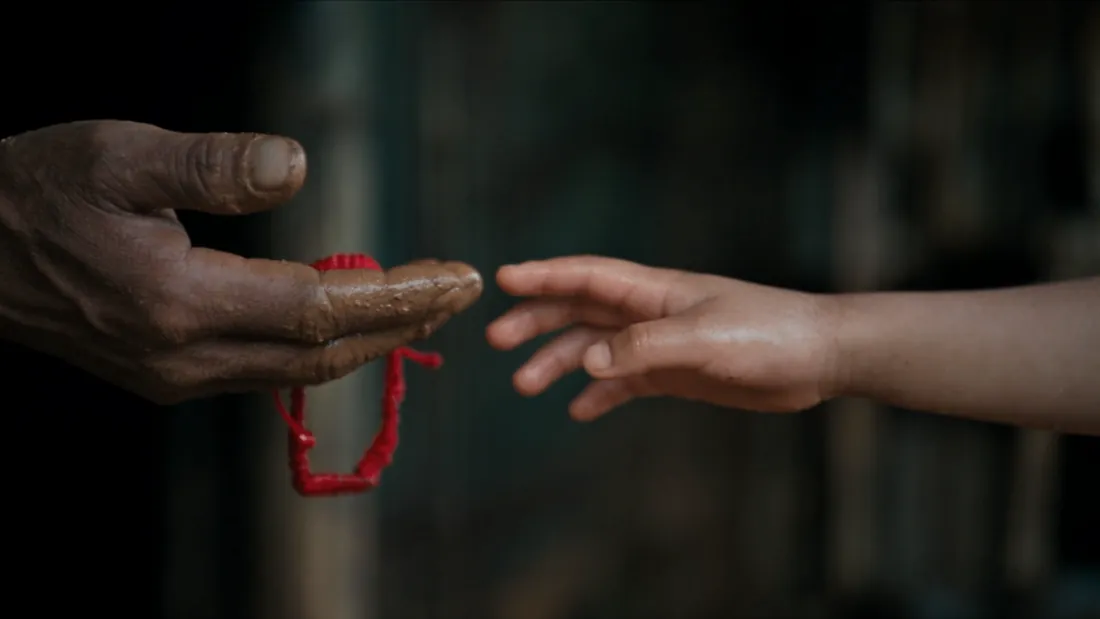 Two hands reaching toward one another in the public-health film on leprosy